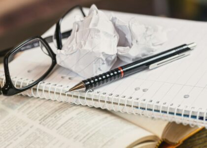 black framed eyeglasses on white paper