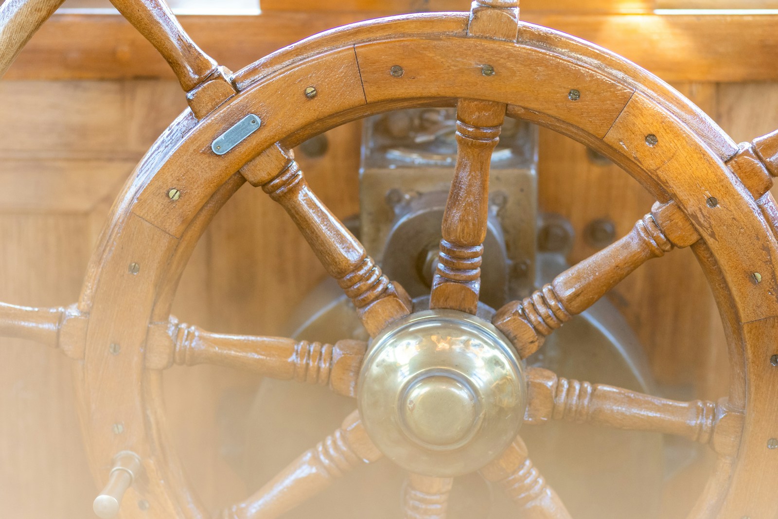 A close up of a steering wheel on a boat