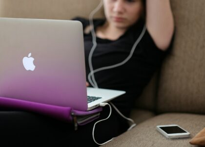 woman sitting on sofa with MacBook Air