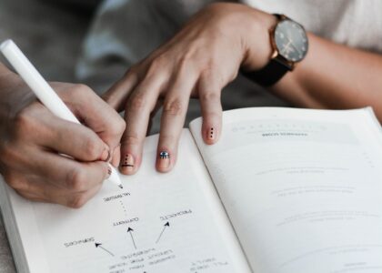 person writing on book