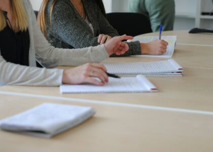 a woman writing on a piece of paper