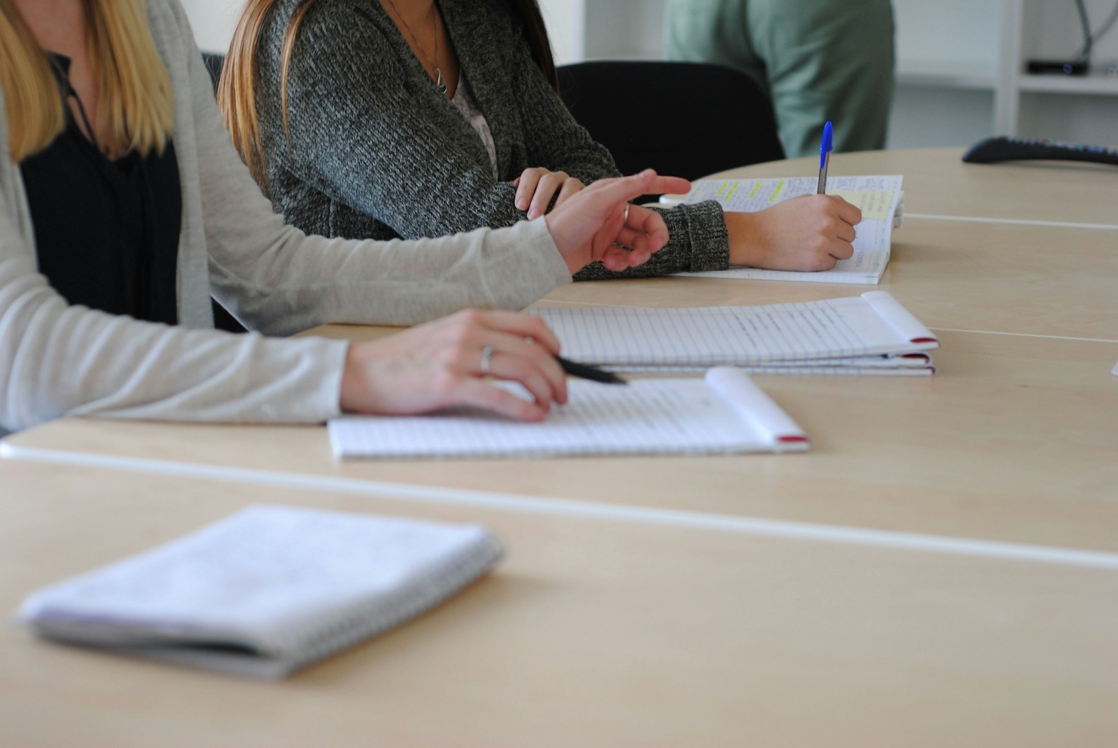 a woman writing on a piece of paper